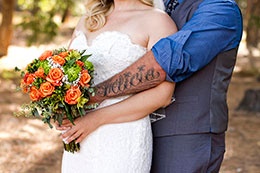 Groom shows his new tattoo of wife's name
