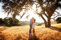 Couple kisses in the sunset above Regusci Vineyards