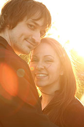 Sun flairs around engaged couples heads in Hoboken, New Jersey